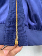 Blue Louis Vuitton jacket zipper with gold pull and textured ribbed panel