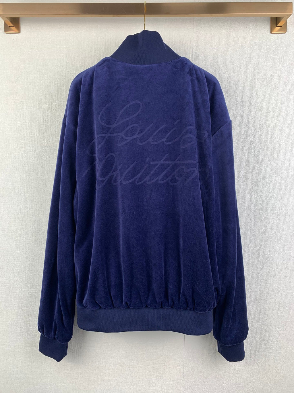 Blue Louis Vuitton zip-up jacket back view with crew logo script on fabric