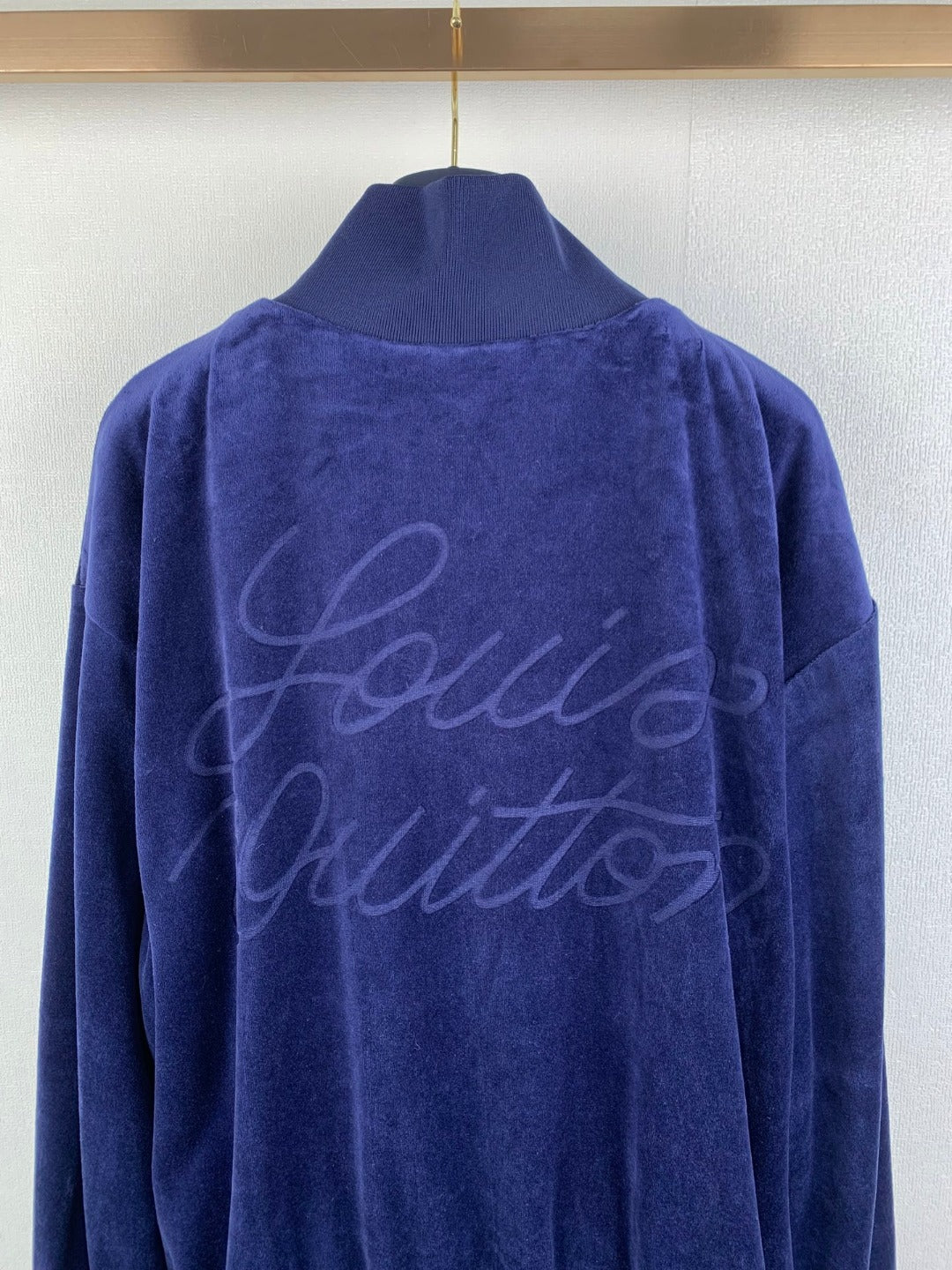 Blue Louis Vuitton jacket back with large signature-style logo script