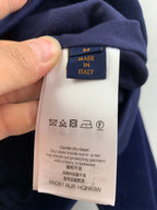 Louis Vuitton long clothes care tag on dark blue long-sleeve garment