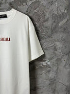 White short-sleeve T-shirt side view with red logo print near chest