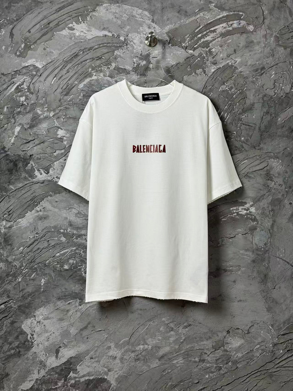 White short-sleeve T-shirt with small red logo print on chest