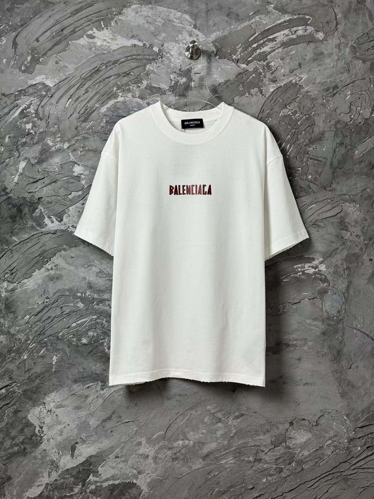 White short-sleeve T-shirt with small red logo print on chest