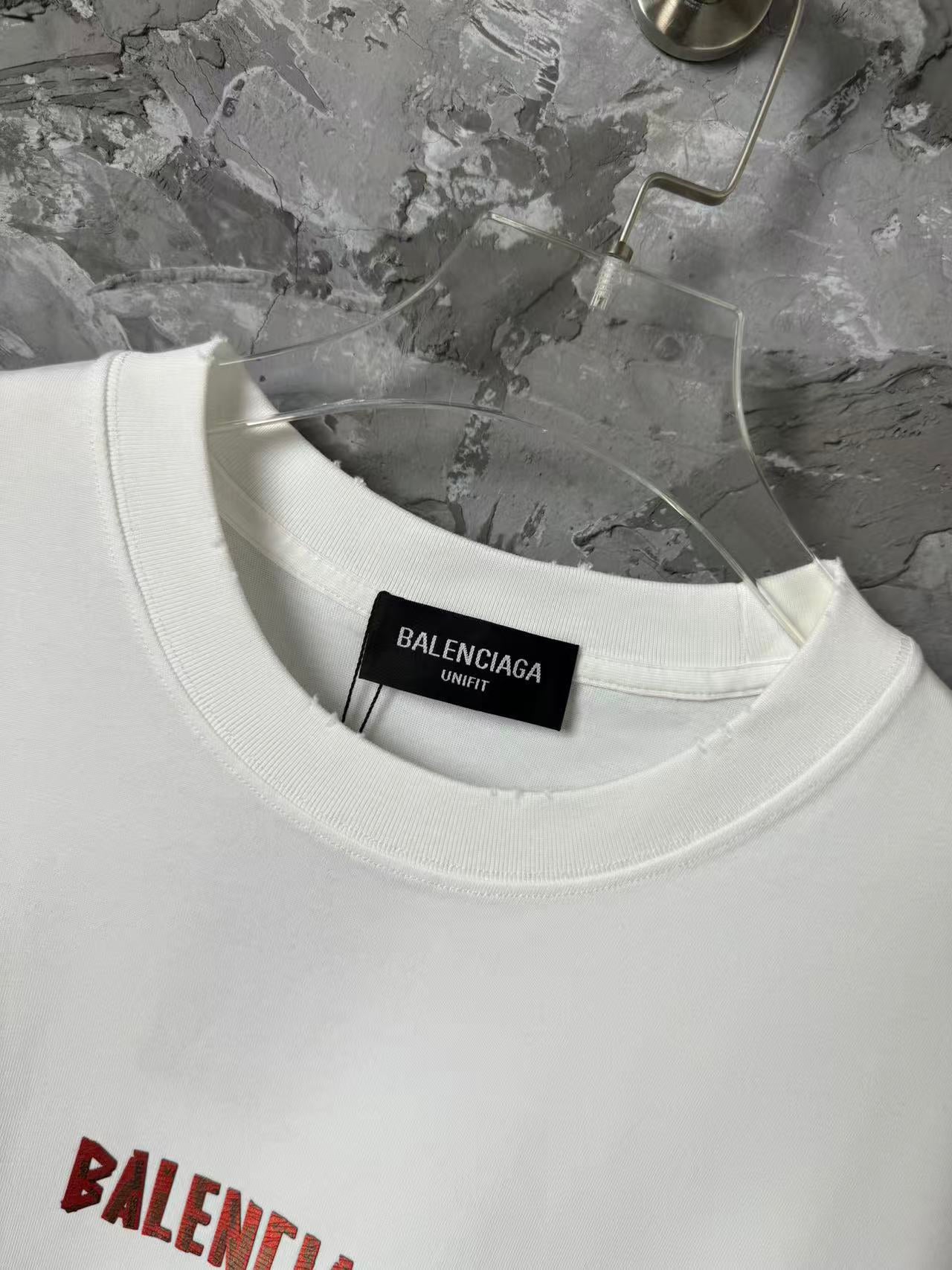 White crewneck T-shirt with black size label inside the collar