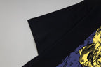 Black T-shirt sleeve and shoulder with yellow graphic detail