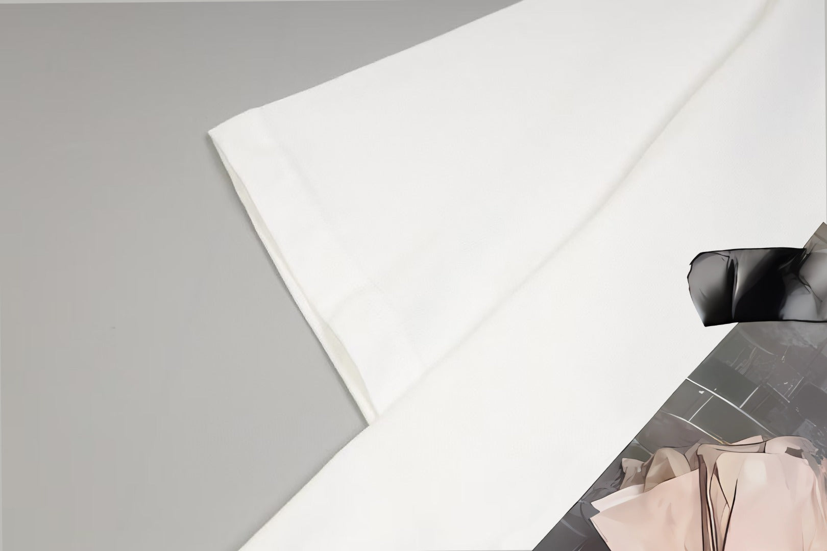 White T-shirt sleeve and front graphic corner close-up