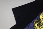 Black T-shirt sleeve with partial blue and yellow graphic print