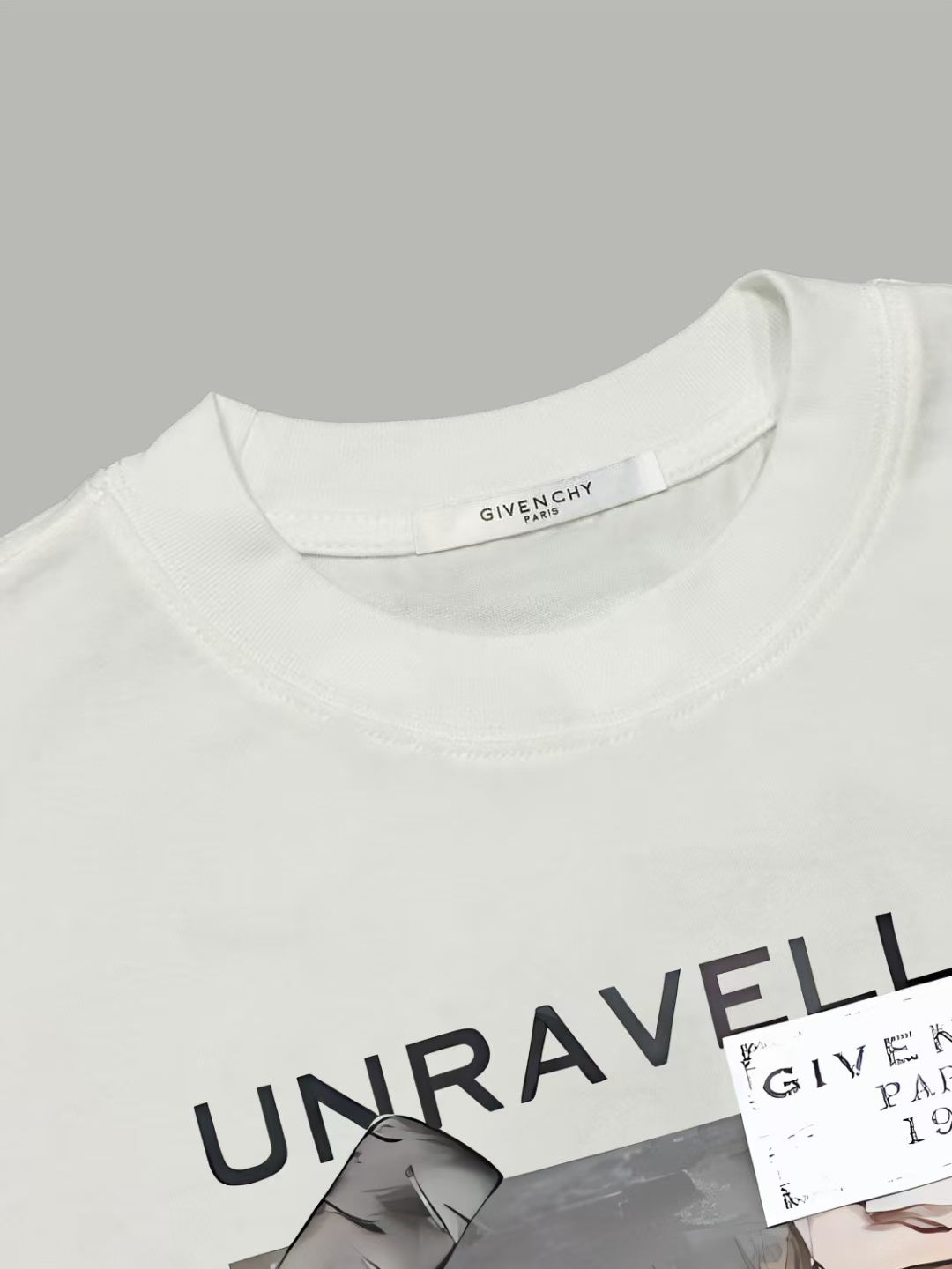White T-shirt neckline with black UNRAVELLED graphic detail
