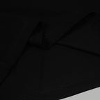Black polo shirt fabric and topstitching close-up