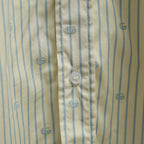 Light blue striped shirt fabric with small GG logos and round button