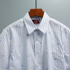Short-sleeve striped button-up shirt with spread collar and blue pinstripes
