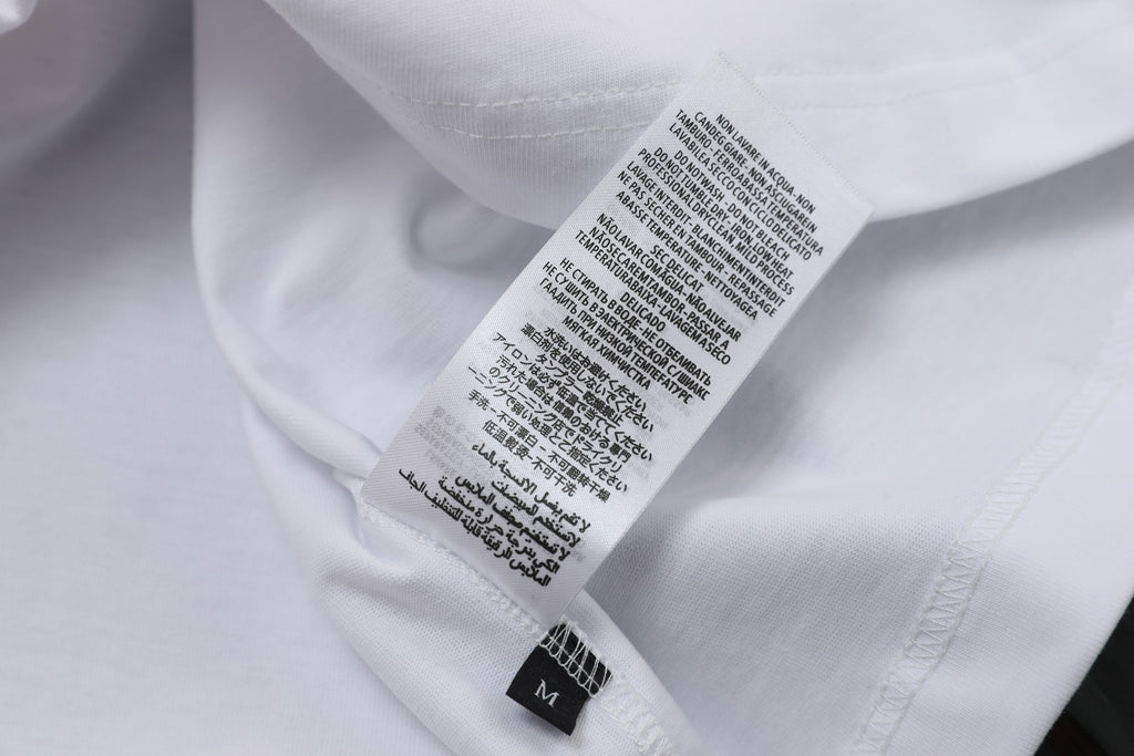 White T-shirt care label and size text on inner back neck