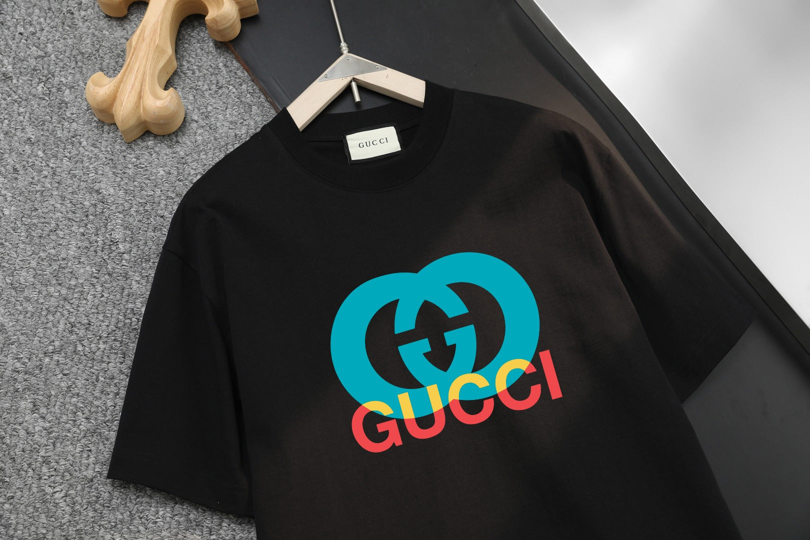 Black Gucci T-shirt with blue and red GG logo graphic
