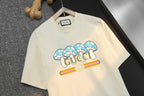 Cream T-shirt front with blue bow graphic and Gucci logo detail