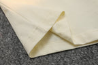 Cream Gucci T-shirt sleeve and side seam, fabric close-up.