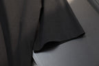 Black T-shirt back hem and fabric drape