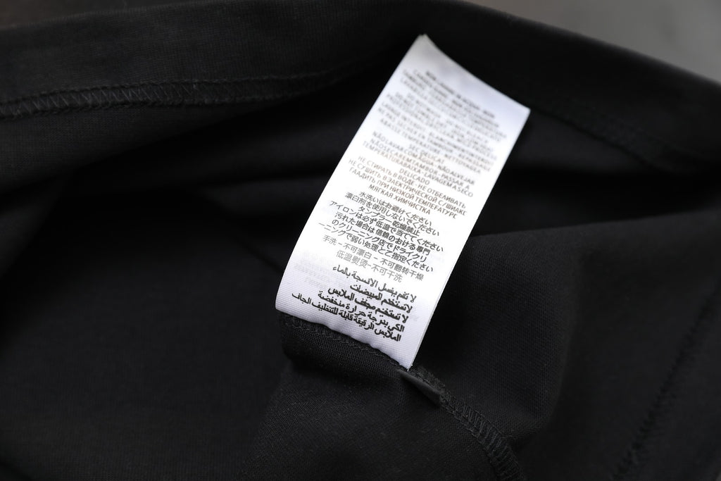 Black T-shirt care label on inner collar