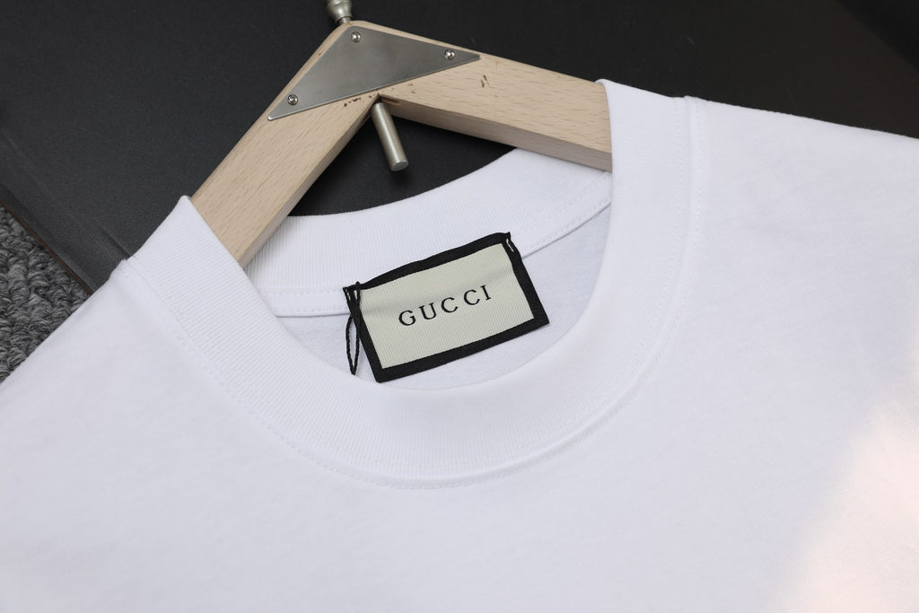 White Gucci short-sleeve T-shirt neckline and Gucci label at collar