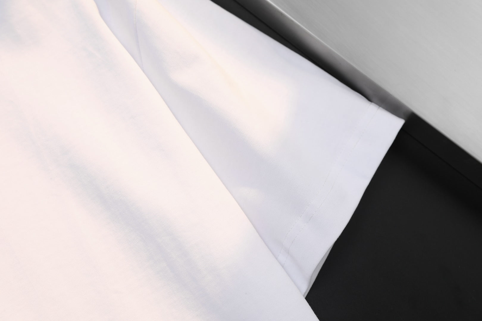 White T-shirt sleeve and hem close-up, short-sleeve style