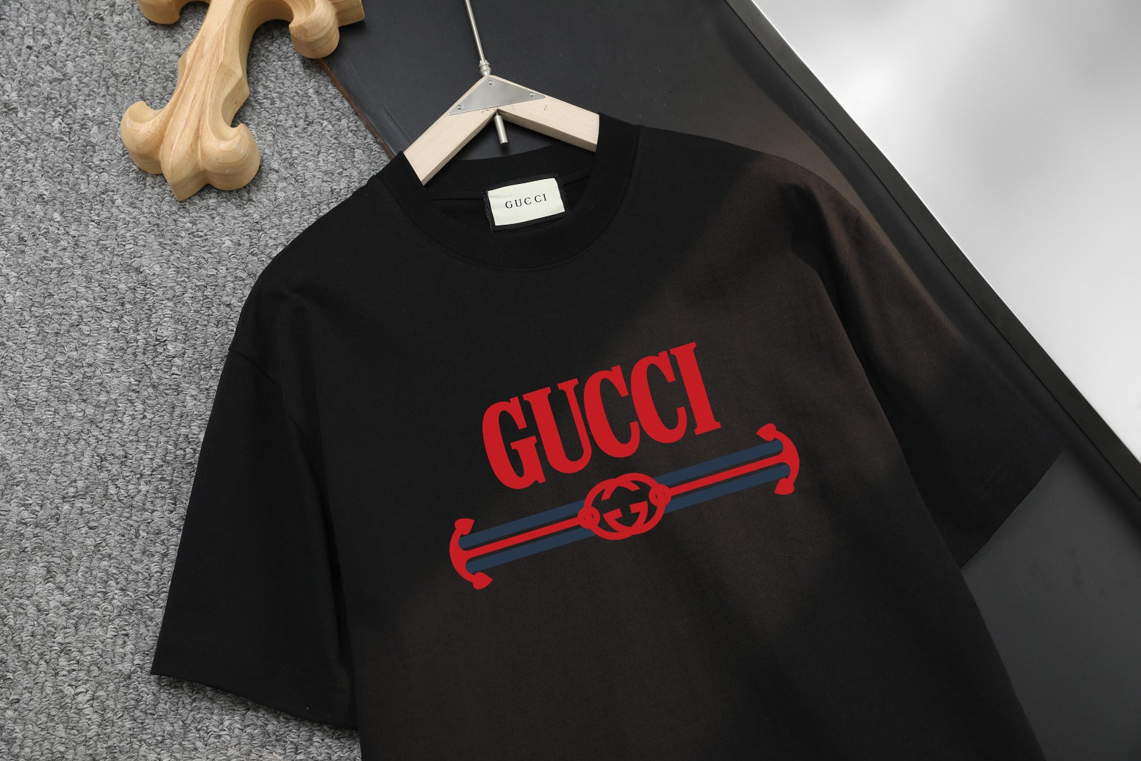 Black Gucci logo T-shirt with red hanger-style graphic
