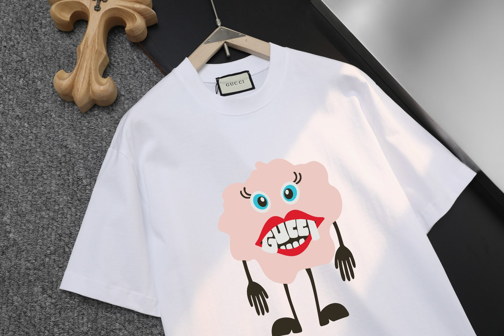 White T-shirt with large cartoon bear graphic centered on the chest