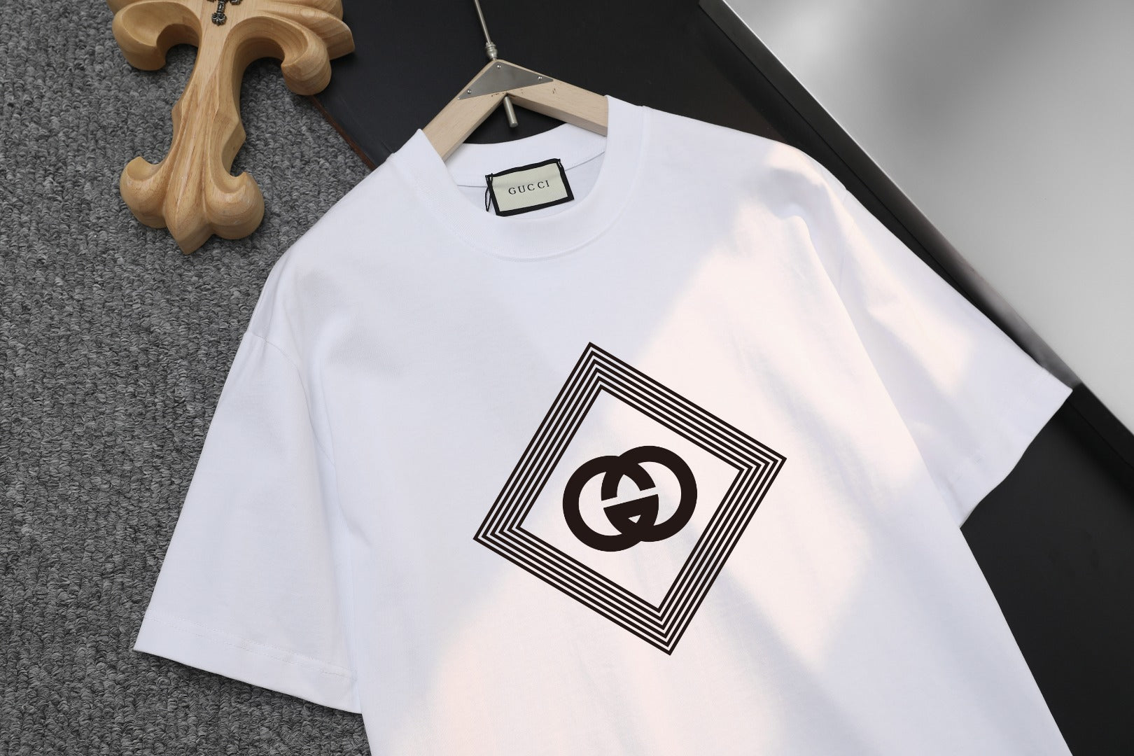 White Gucci short-sleeve T-shirt showing black diamond logo graphic