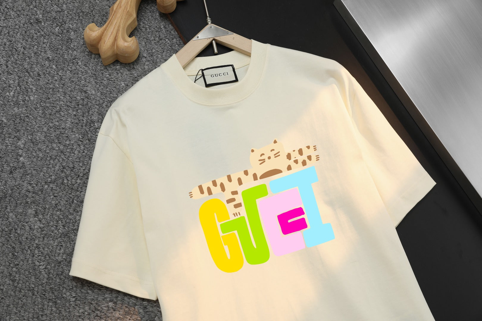 Cream short-sleeve T-shirt with “GGE” graphic print, close-up