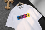 White short-sleeve T-shirt with large multicolor GUCCI logo, front view