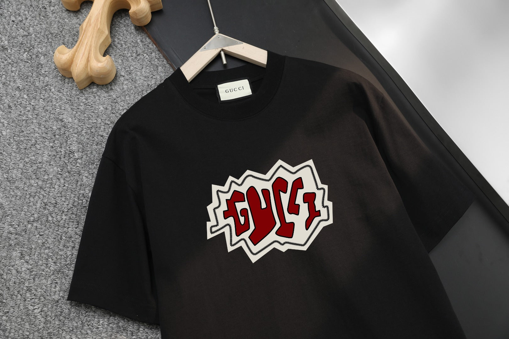 Black Gucci graphic short-sleeve T-shirt on hanger, crew neck