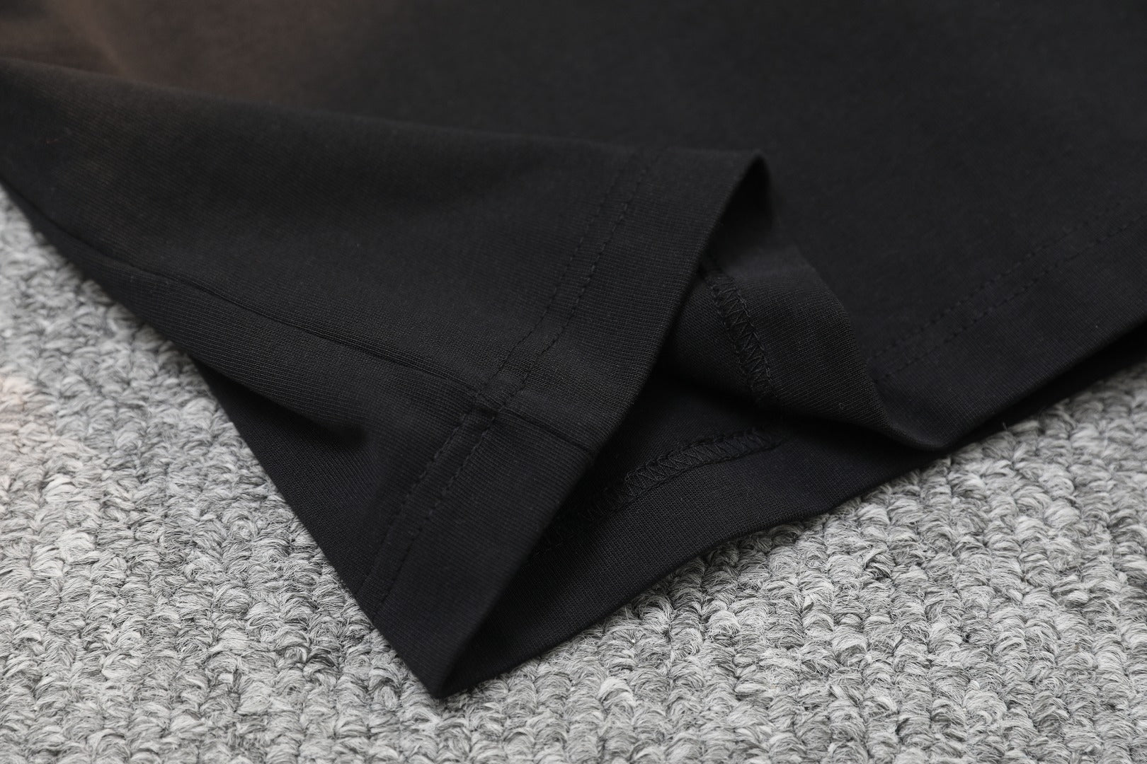 Black T-shirt fabric fold and stitched hem
