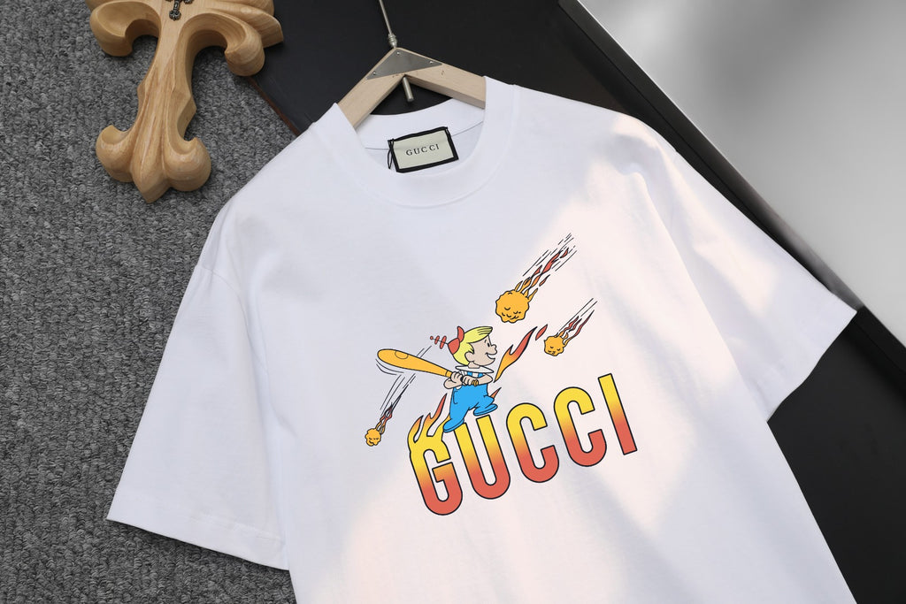 White short-sleeve T-shirt showing GUCCI logo and cartoon graphic detail