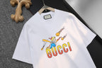 White short-sleeve T-shirt showing GUCCI logo and cartoon graphic detail