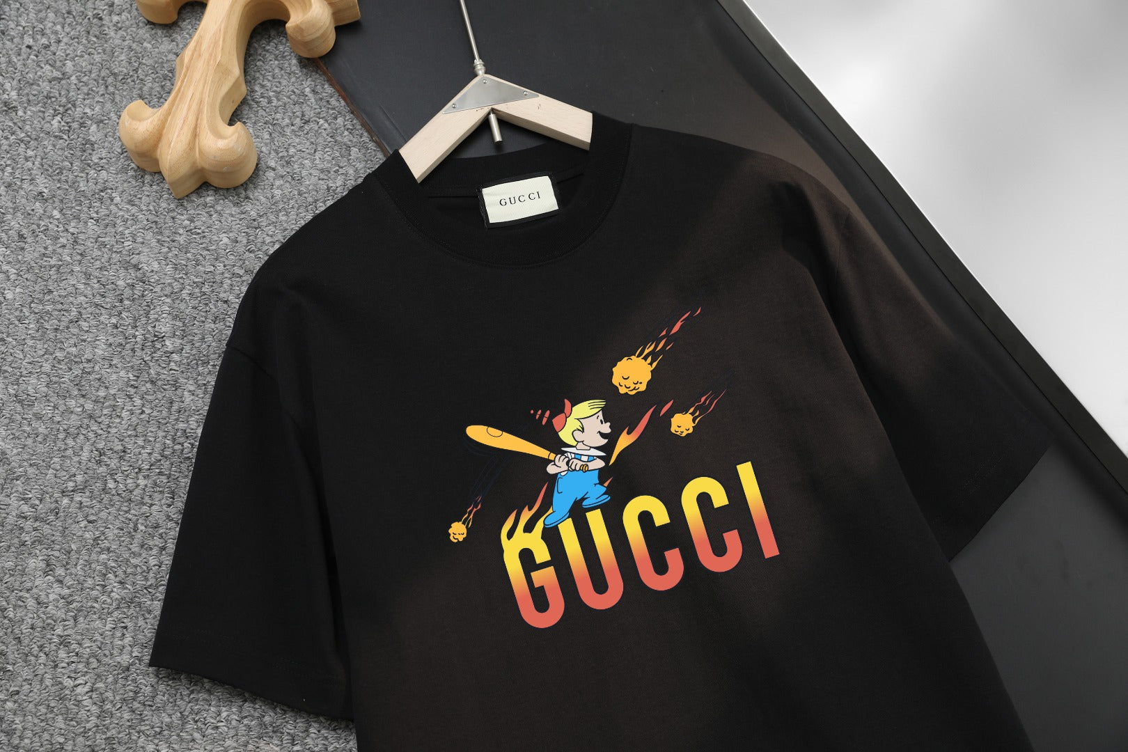 Black Gucci T-shirt with 'GUCCI' logo and cartoon graphic