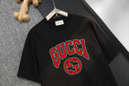 Black T-shirt with large GUCCI lettering and GG emblem graphic on the chest