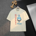 Cream Gucci graphic T-shirt with cartoon print and logo lettering