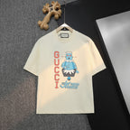 Cream Gucci graphic T-shirt with cartoon print and logo lettering