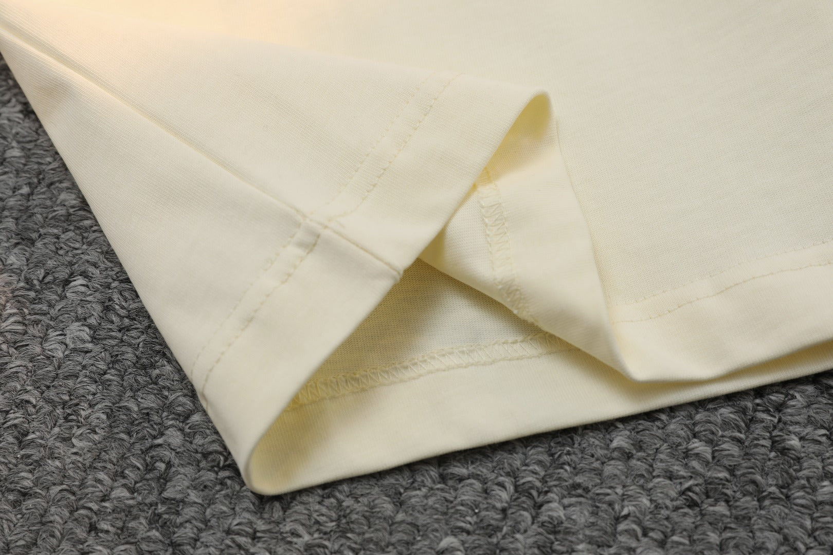 Light cream T-shirt with stitched bottom hem detail