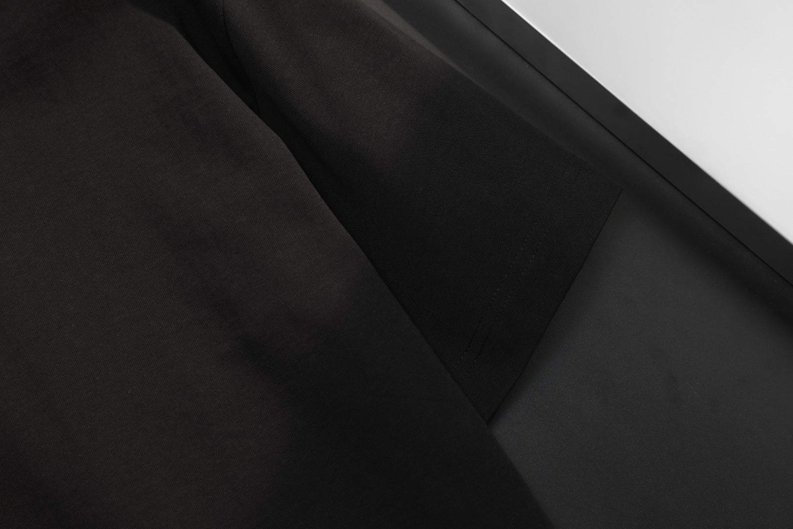 Black short-sleeve T-shirt fabric panel on hanger