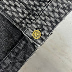 Louis Vuitton denim hem close-up with circular gold logo button