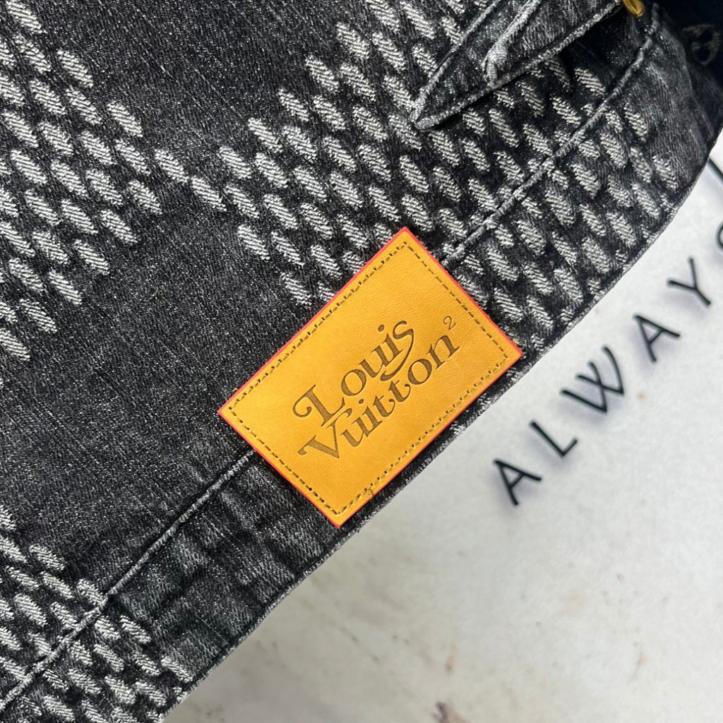 Louis Vuitton denim tag in orange on herringbone fabric