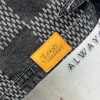 Louis Vuitton denim tag in orange on herringbone fabric