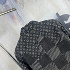 Louis Vuitton denim jacket side close-up with monogram print and patchwork panel