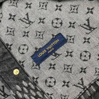 Louis Vuitton denim fabric close-up with all-over monogram and blue brand label