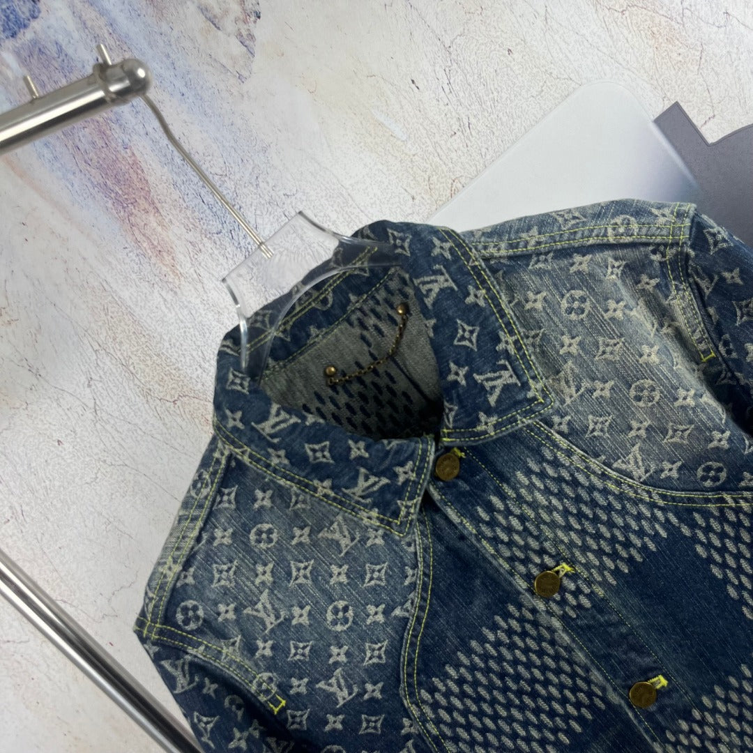 Monogram denim jacket detail with curved yoke seam and gold-tone buttons