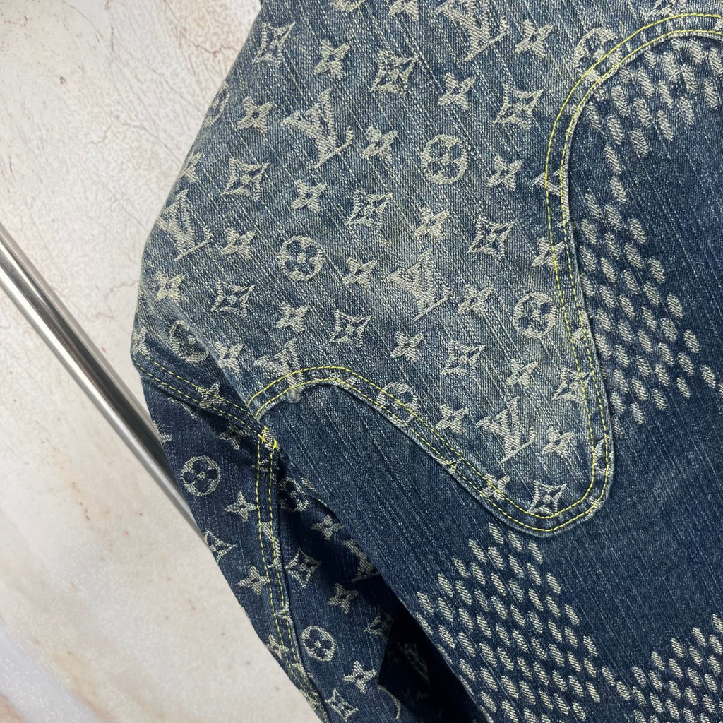 Monogram denim jacket sleeve close-up with blue patchwork trim stitching