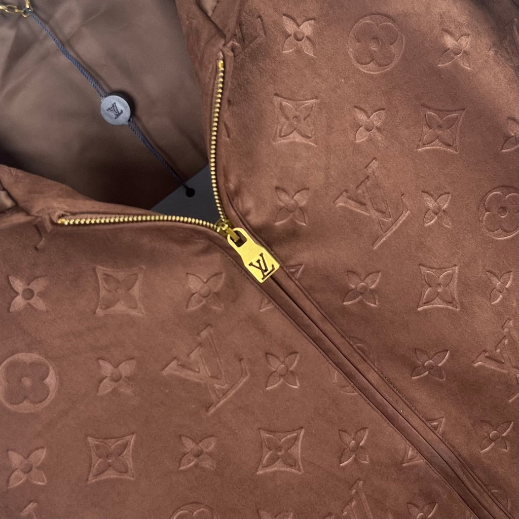 Brown monogram zip-up jacket detail with gold zipper and hood hardware