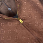Brown monogram zip-up jacket detail with gold zipper and hood hardware