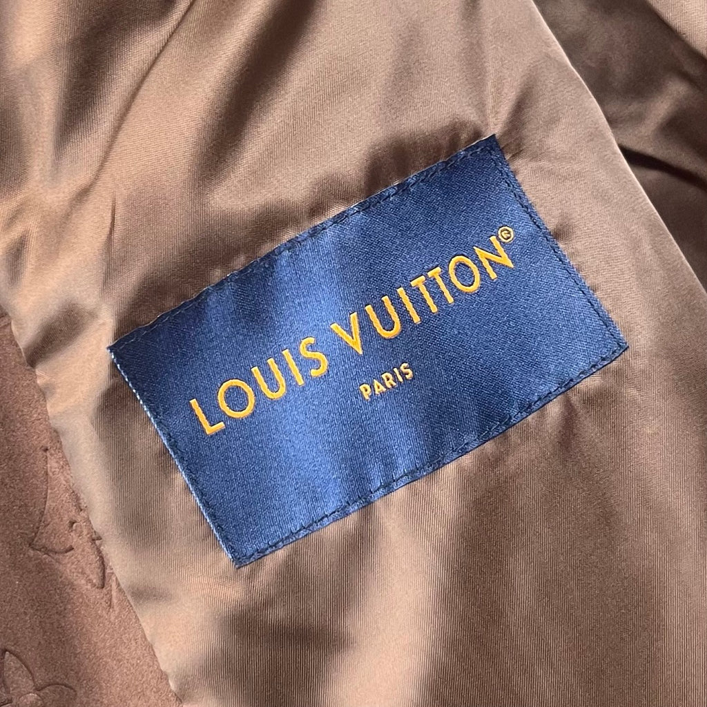 Louis Vuitton brand label on brown monogram hooded jacket