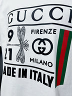 Gucci white T-shirt front logo print close-up with numbers and badge graphic
