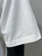 Gucci white T-shirt sleeve hem with visible stitching and curved cut